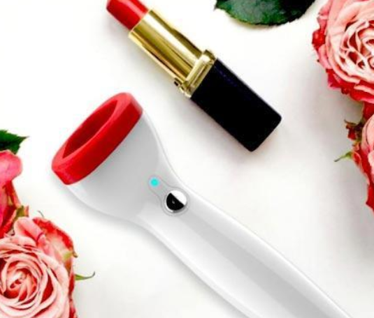 Red-tipped facial massager with rose and lipstick, beauty gadget for skincare routine